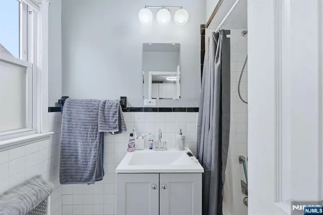 a bathroom with a sink a mirror and shower