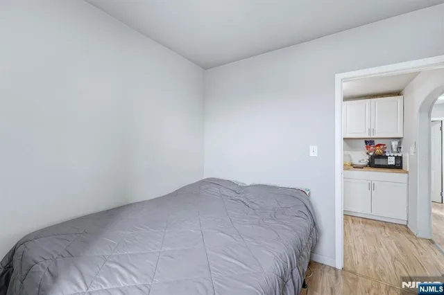 a bedroom with a bed and a stove