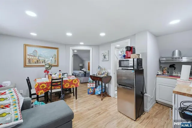 a living room with furniture and a kitchen view