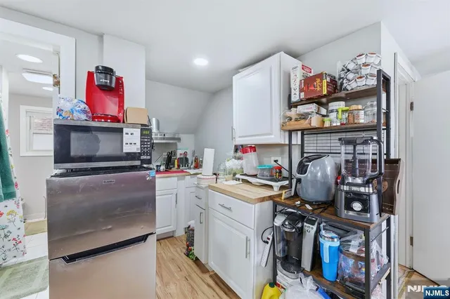 a open kitchen with stainless steel appliances granite countertop a stove and cabinets