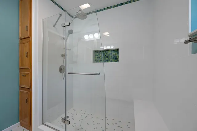 a bathroom with a shower and a mirror