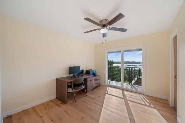a workspace with wooden floor and a window