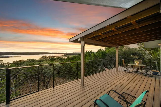 a view of a roof deck with wooden floor and iron stairs