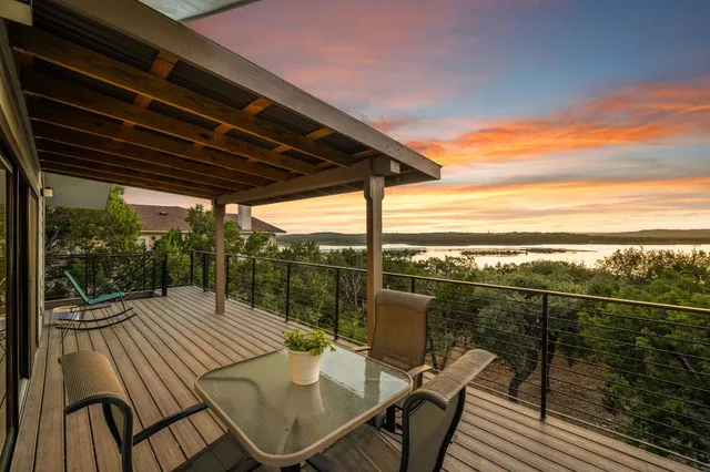 a view of a balcony with table and chairs and wooden floor