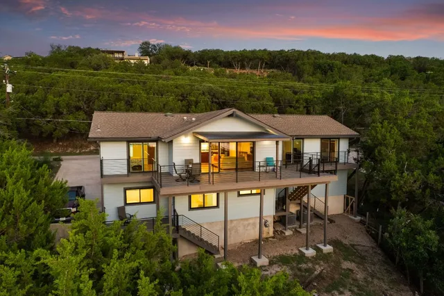 a front view of a house with yard and green space
