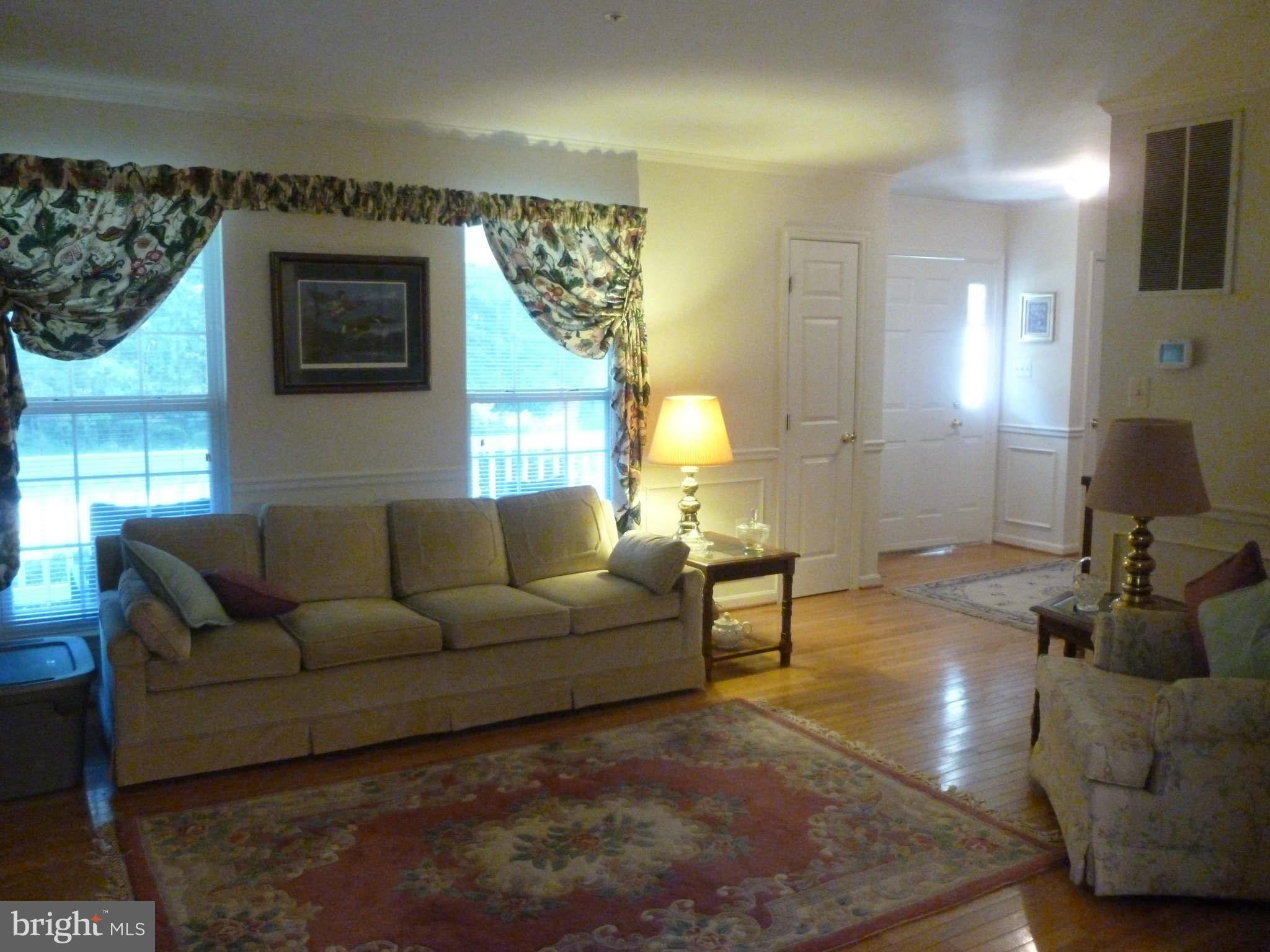 670 Small Reward Road Huntingtown, MD 20639 - Photo 5 of 26 a living room with furniture and a chandelier