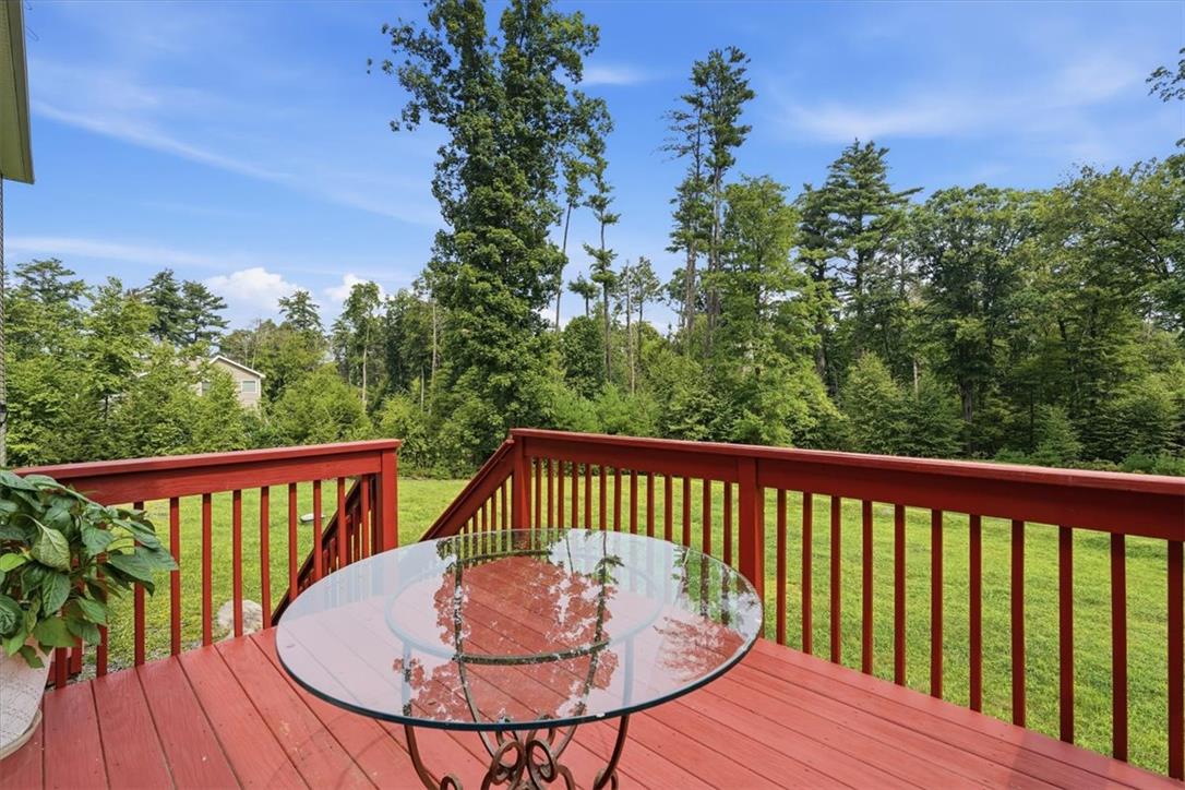 5032 Custard Road Stroudsburg, PA 18360 - Photo 64 of 80 A spacious wooden deck overlooks a grassy yard bordered by towering mature trees.