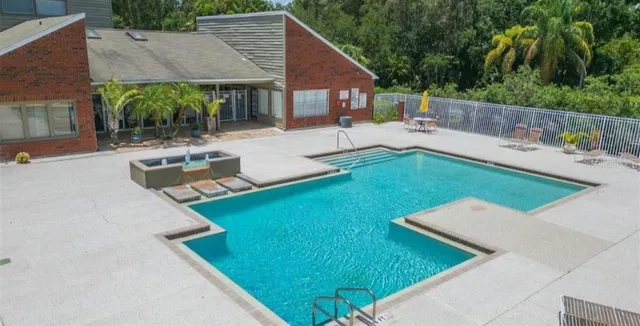 a view of house with yard and outdoor seating