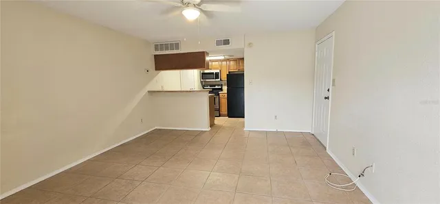 a view of a kitchen with a sink and a refrigerator