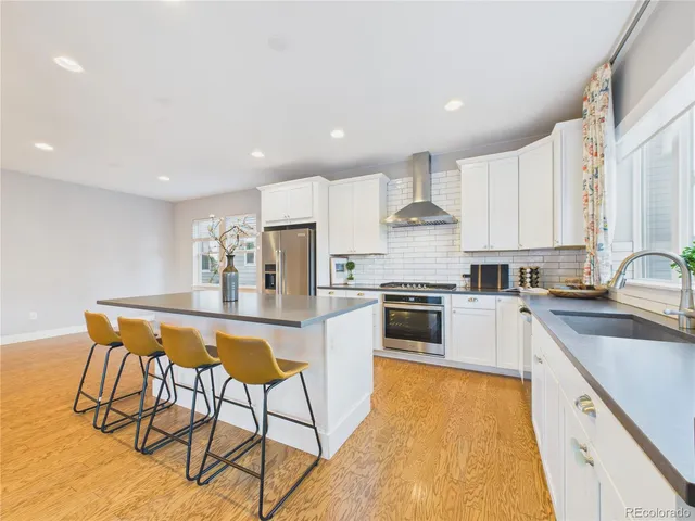 a kitchen with stainless steel appliances kitchen island granite countertop a sink and cabinets