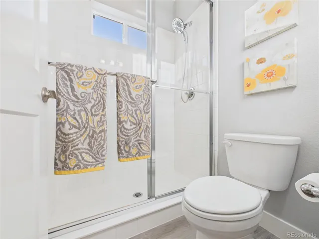 a white toilet sitting next to a shower curtain