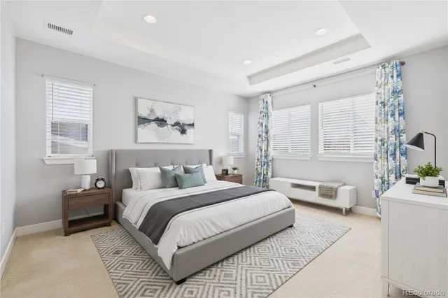 a bedroom with a large bed and a couch