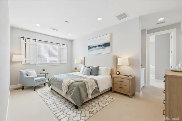 a bedroom with a bed and a couch