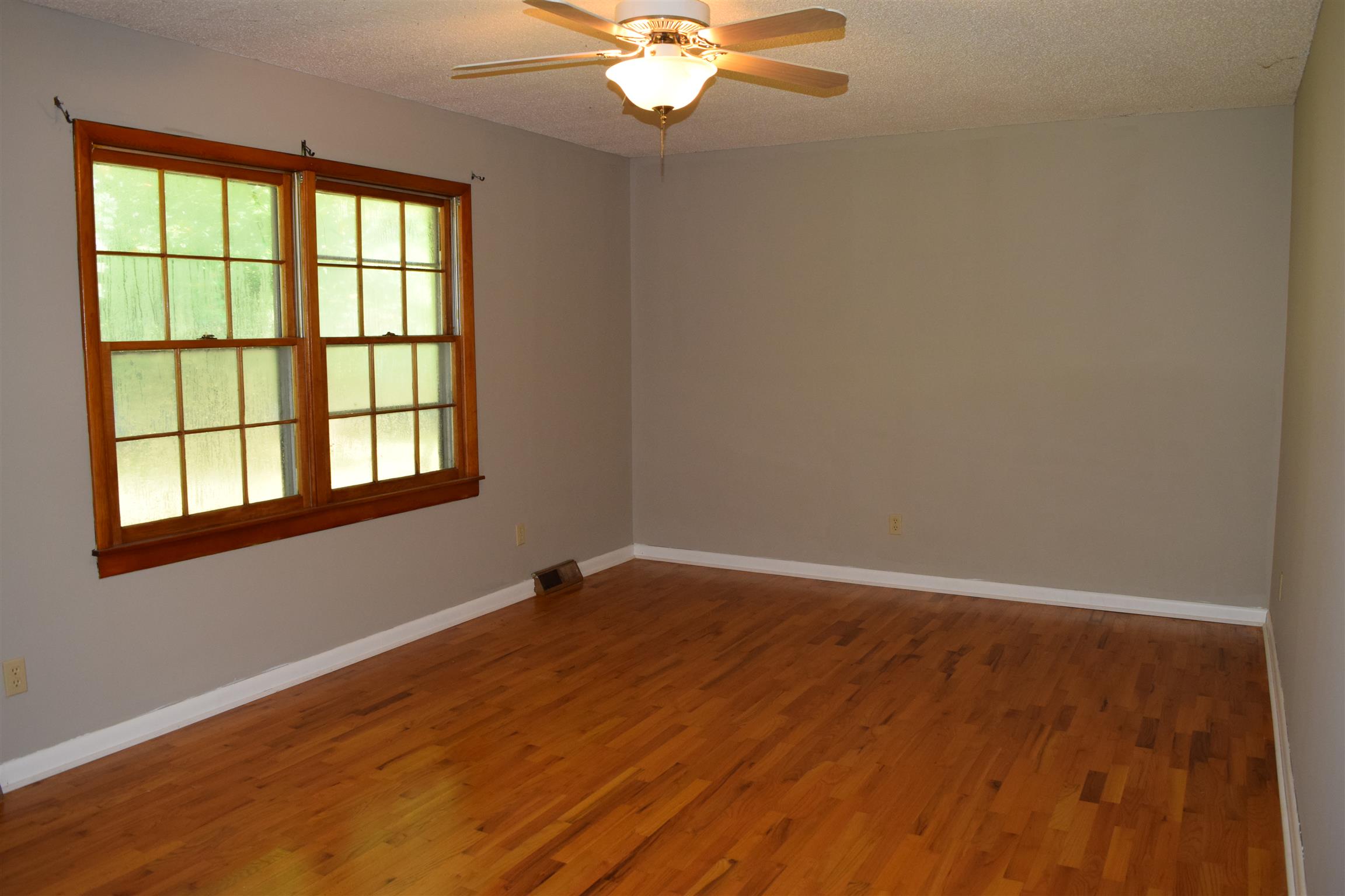 100 Towering Oaks Road Tennessee Ridge, TN 37178 - Photo 4 of 16 wooden floor in an empty room with a window