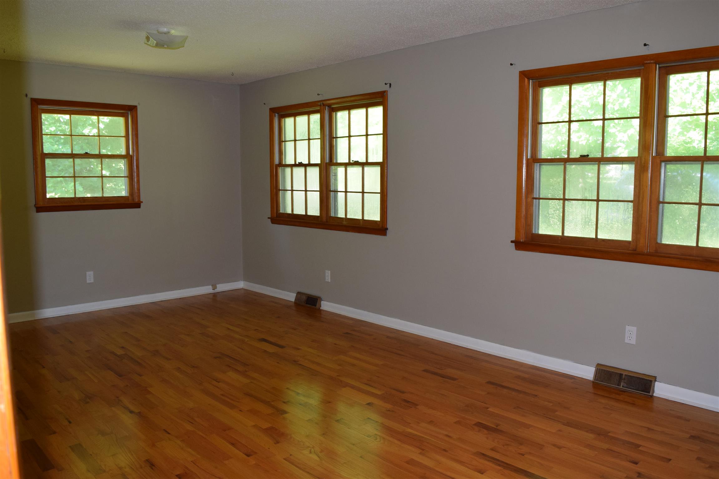100 Towering Oaks Road Tennessee Ridge, TN 37178 - Photo 5 of 16 an empty room with wooden floor and windows