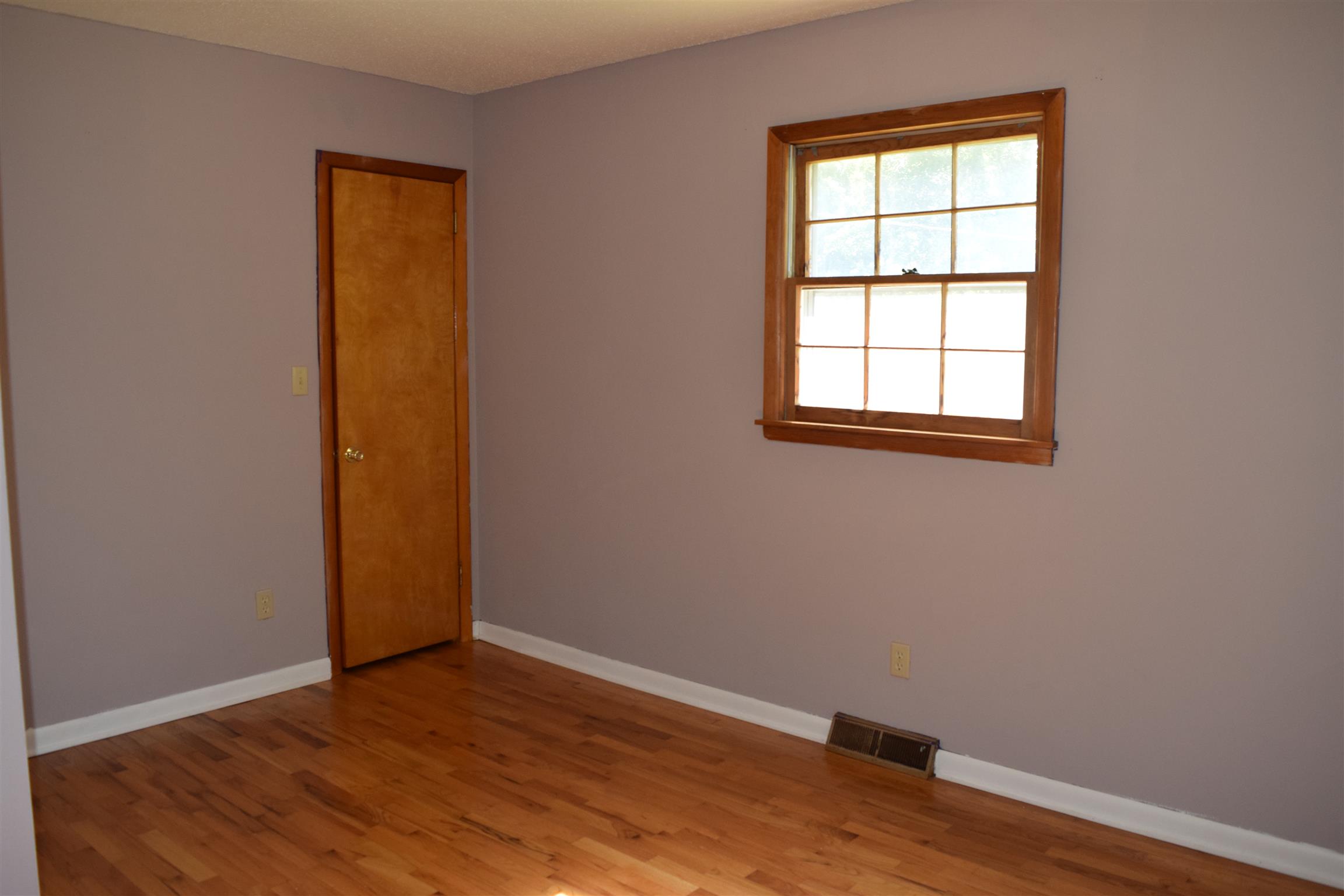 100 Towering Oaks Road Tennessee Ridge, TN 37178 - Photo 6 of 16 an empty room with wooden floor and windows