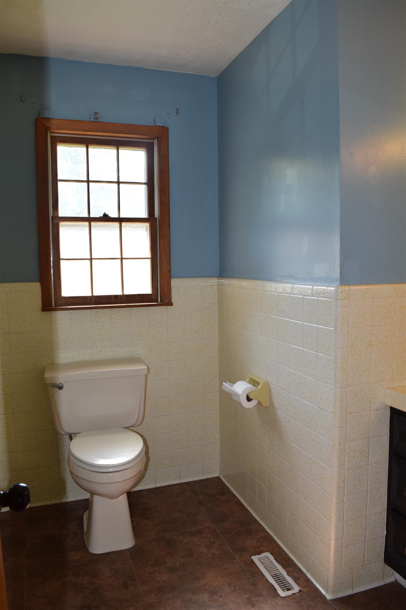 100 Towering Oaks Road Tennessee Ridge, TN 37178 - Photo 7 of 16 a white toilet sitting in a bathroom next to a window