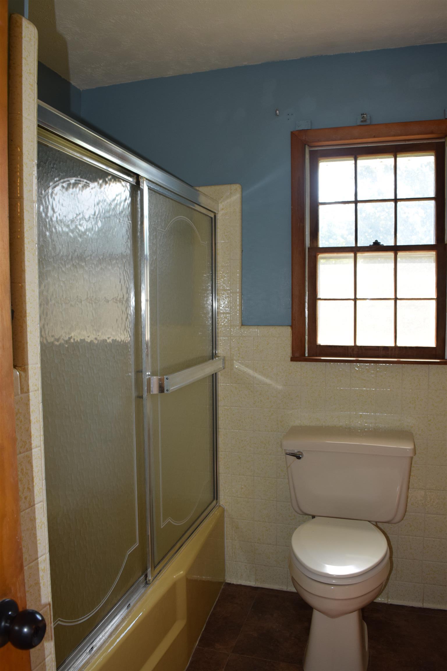 100 Towering Oaks Road Tennessee Ridge, TN 37178 - Photo 8 of 16 a bathroom with a toilet and a shower