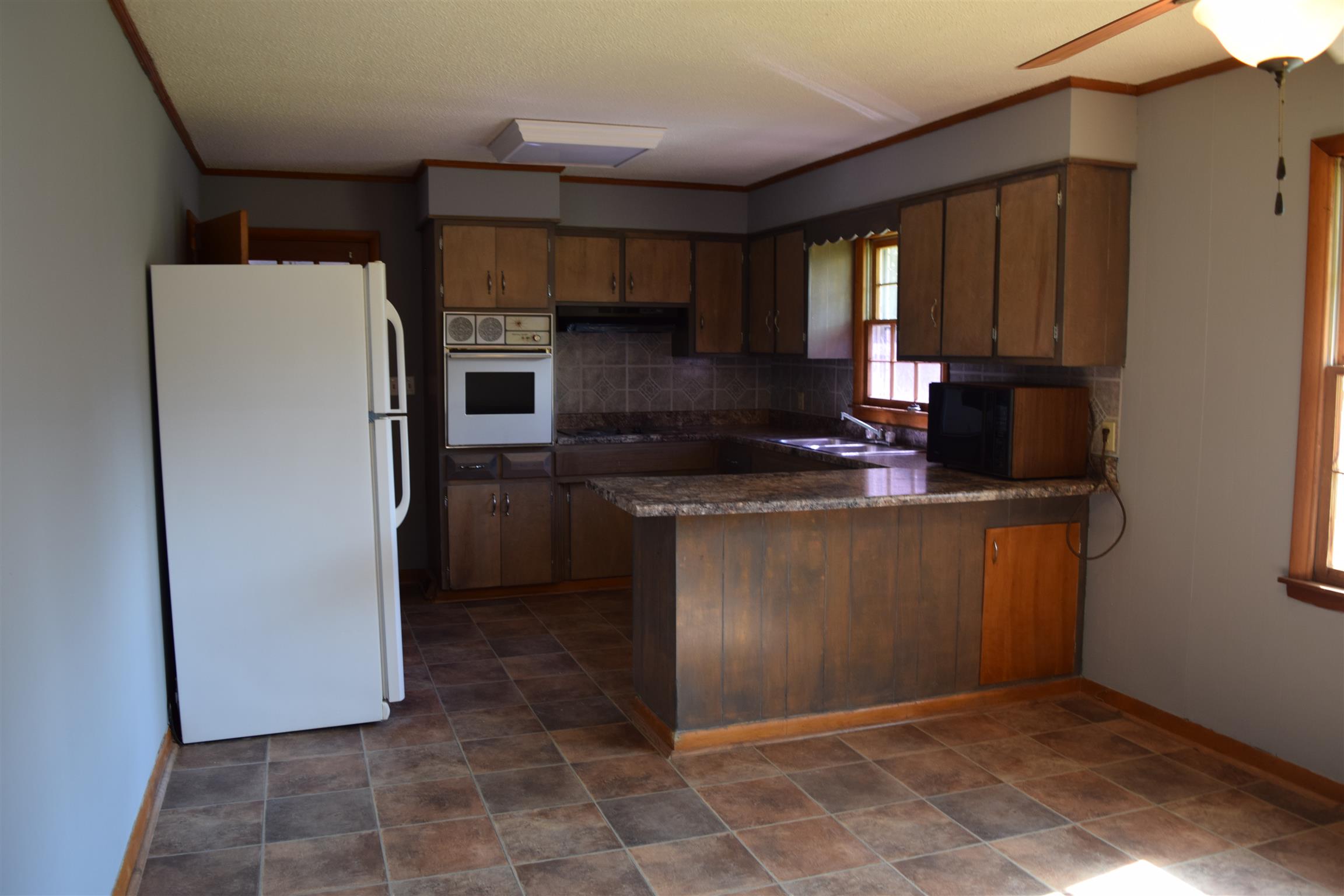 100 Towering Oaks Road Tennessee Ridge, TN 37178 - Photo 10 of 16 a kitchen with stainless steel appliances granite countertop a refrigerator a stove a sink and a microwave