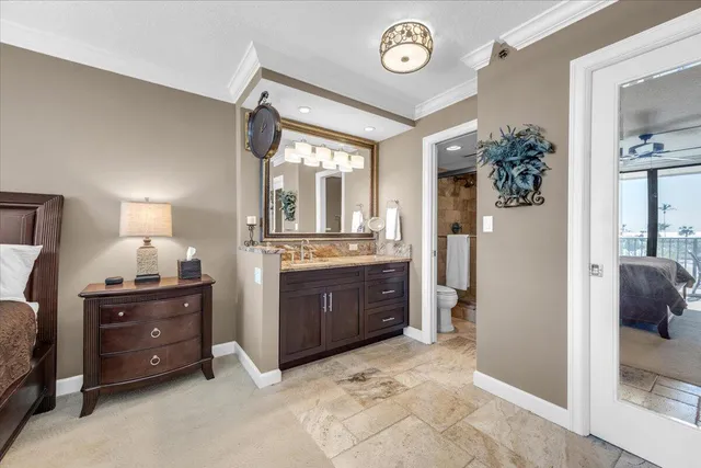 a spacious bathroom with a granite countertop sink and a mirror