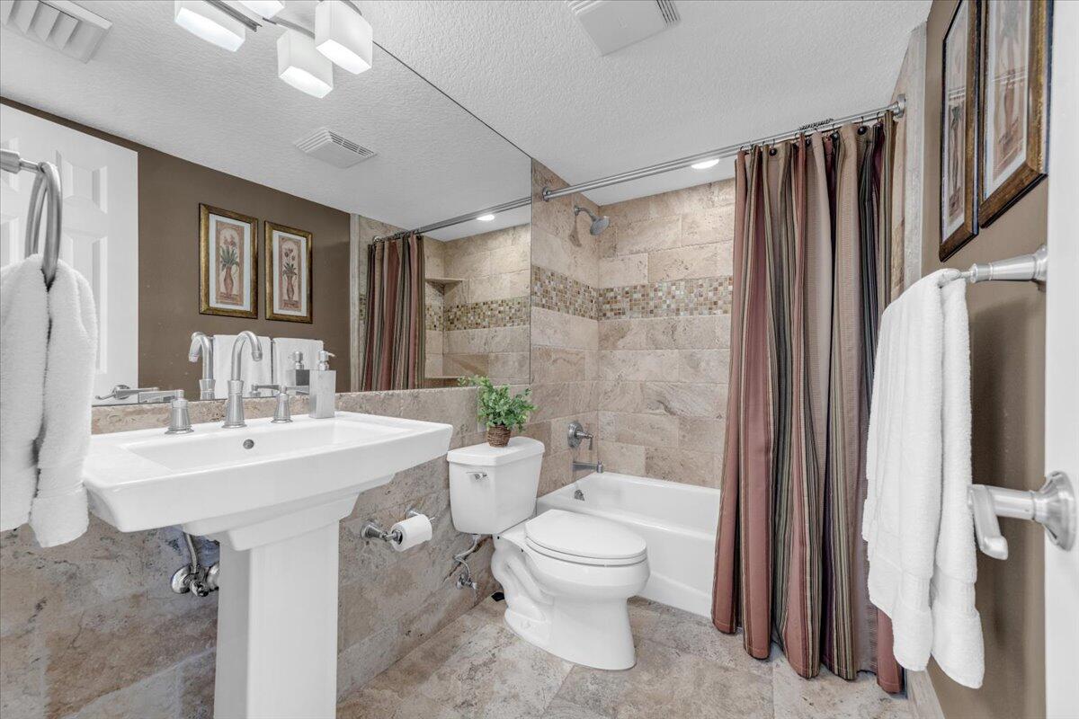 200 Ocean Trail Way, Unit 108 Jupiter, FL 33477 - Photo 21 of 38 a bathroom with a sink toilet and shower