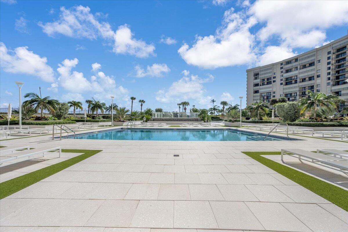 200 Ocean Trail Way, Unit 108 Jupiter, FL 33477 - Photo 25 of 38 a view of a swimming pool and an outdoor seating