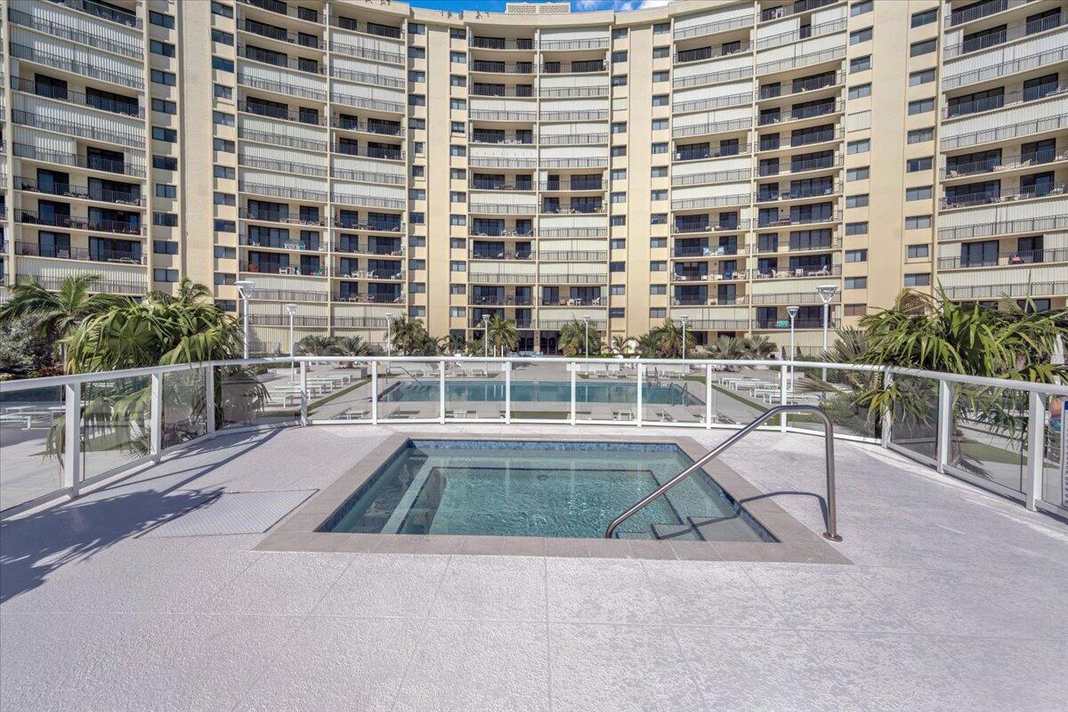 200 Ocean Trail Way, Unit 108 Jupiter, FL 33477 - Photo 26 of 38 a view of a swimming pool with a chair
