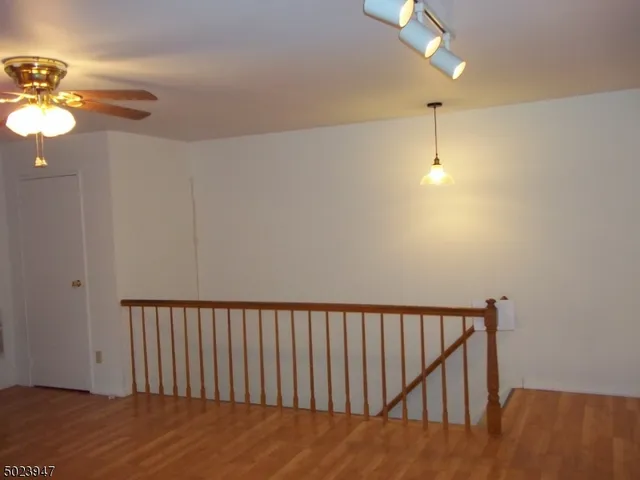 a view of an empty room with glass door and a window