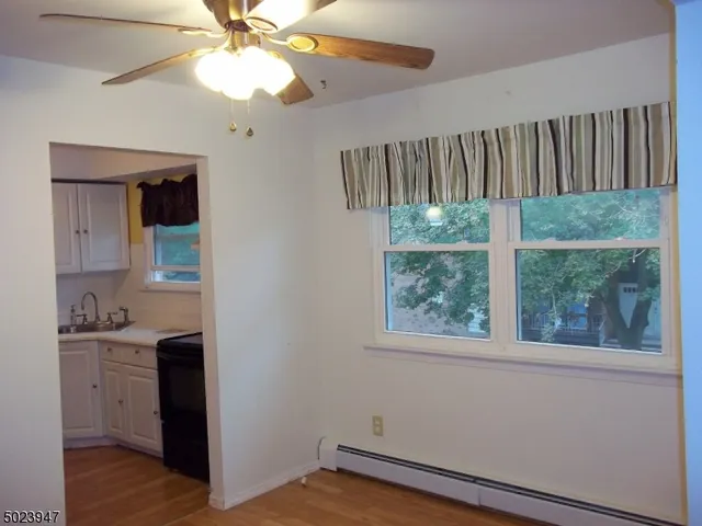 a view of storage and utility room with wooden floor