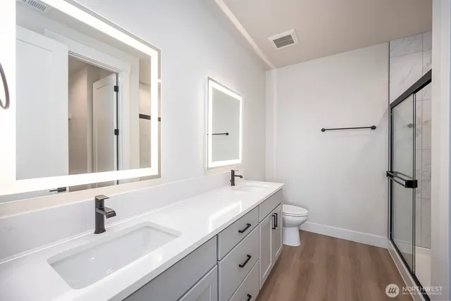 a bathroom with a toilet and a shower