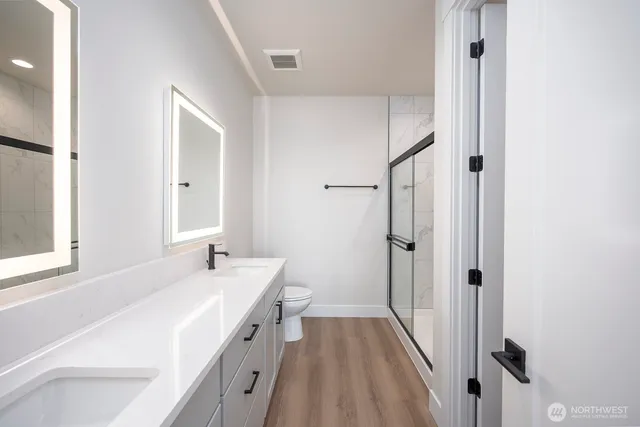 a bathroom with a sink a mirror and a shower