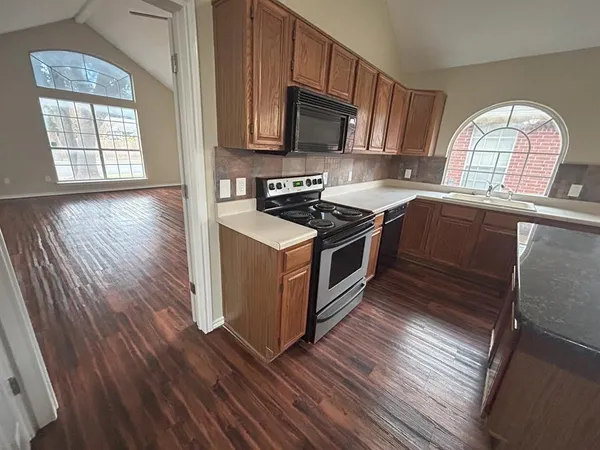 a kitchen with wooden floors and a stove