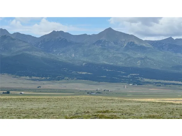 a picture of a field with mountains in the background