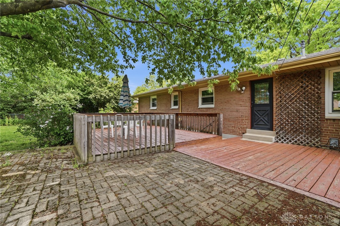 6119 Flemington Road Dayton, OH 45459 - Photo 61 of 76 This outdoor space offers a delightful combination of a wooden deck and a brick patio.
