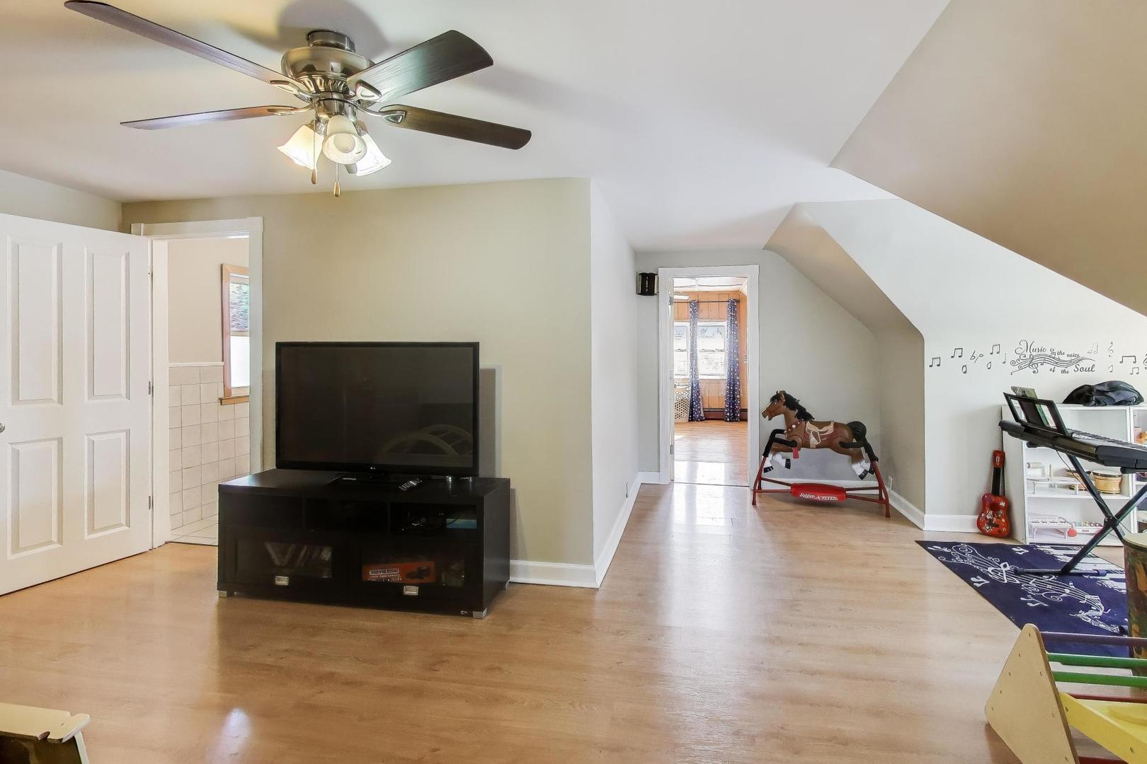 29 Iowa Avenue Addison, IL 60101 - Photo 14 of 31 a view of a livingroom with furniture and a flat screen tv
