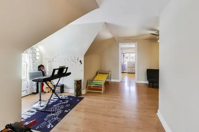 a spacious bedroom with a bed and a chandelier