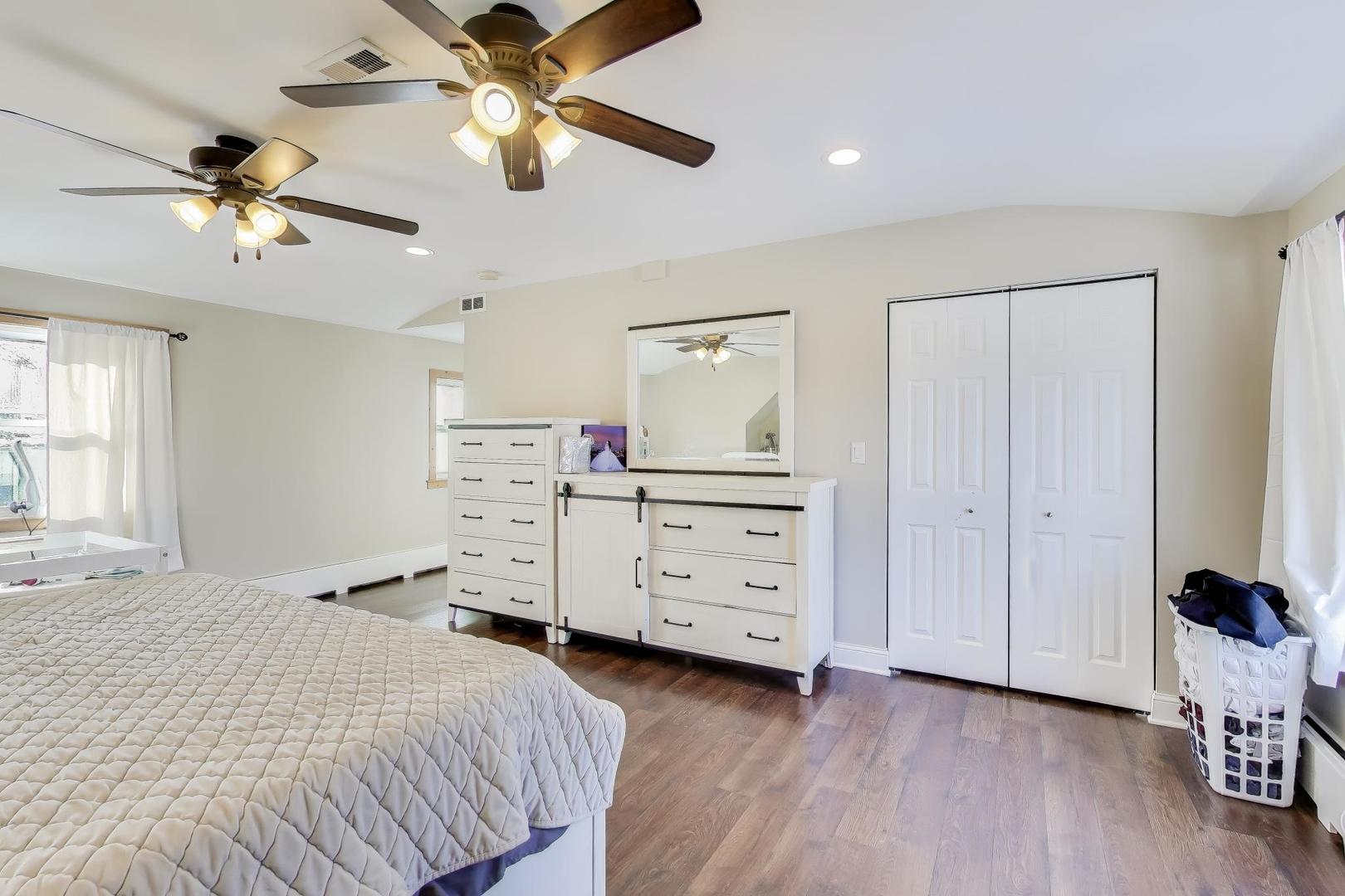 29 Iowa Avenue Addison, IL 60101 - Photo 17 of 31 a bedroom with a bed and a chandelier