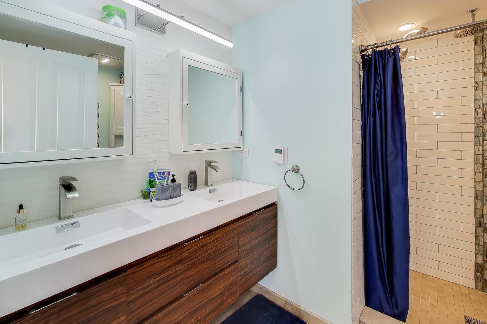 29 Iowa Avenue Addison, IL 60101 - Photo 18 of 31 a bathroom with a double vanity sink and mirror