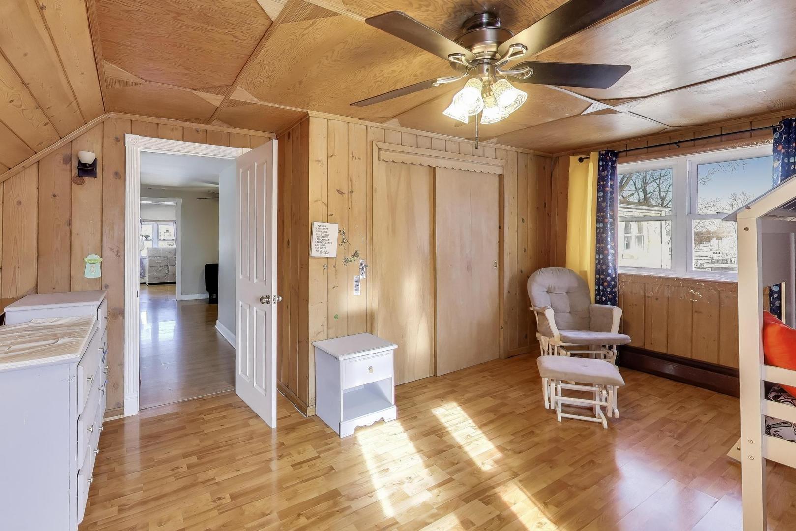 29 Iowa Avenue Addison, IL 60101 - Photo 20 of 31 a living room with furniture and a chandelier