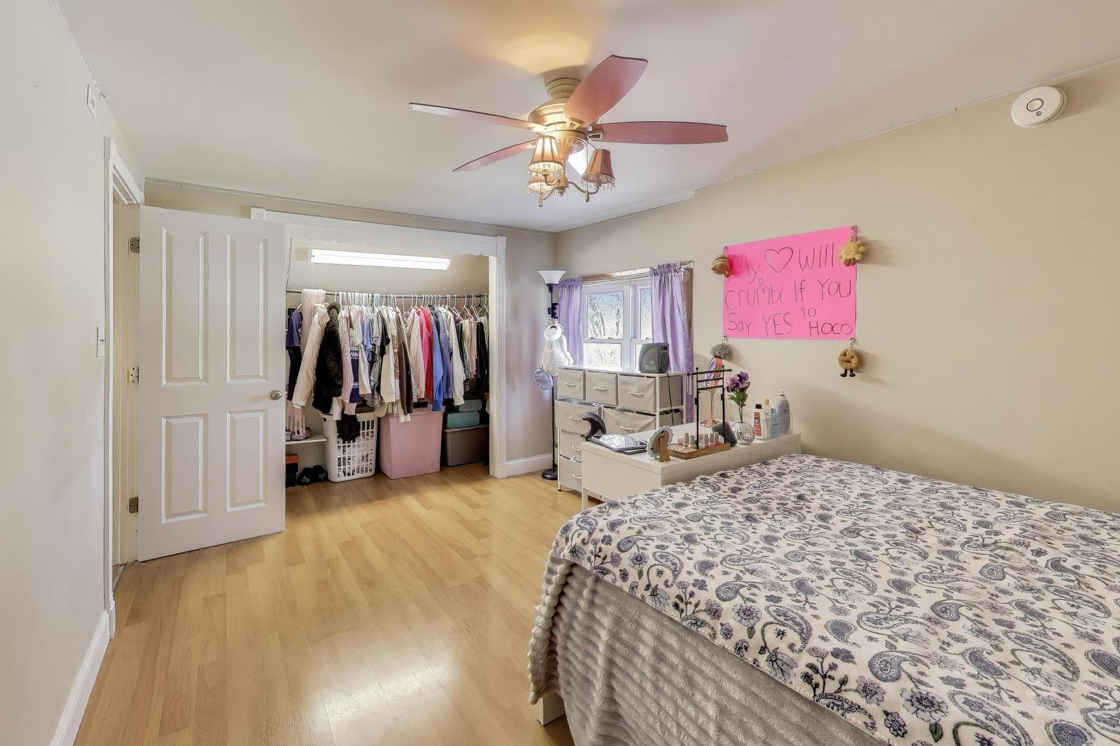 29 Iowa Avenue Addison, IL 60101 - Photo 22 of 31 a bedroom with a bed and a chandelier