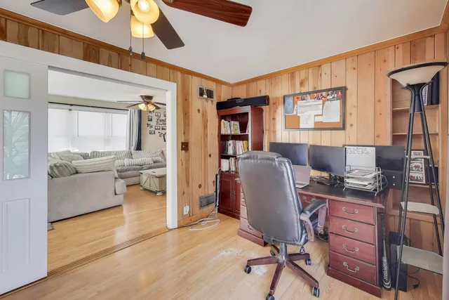 a view of a workspace with furniture and a window