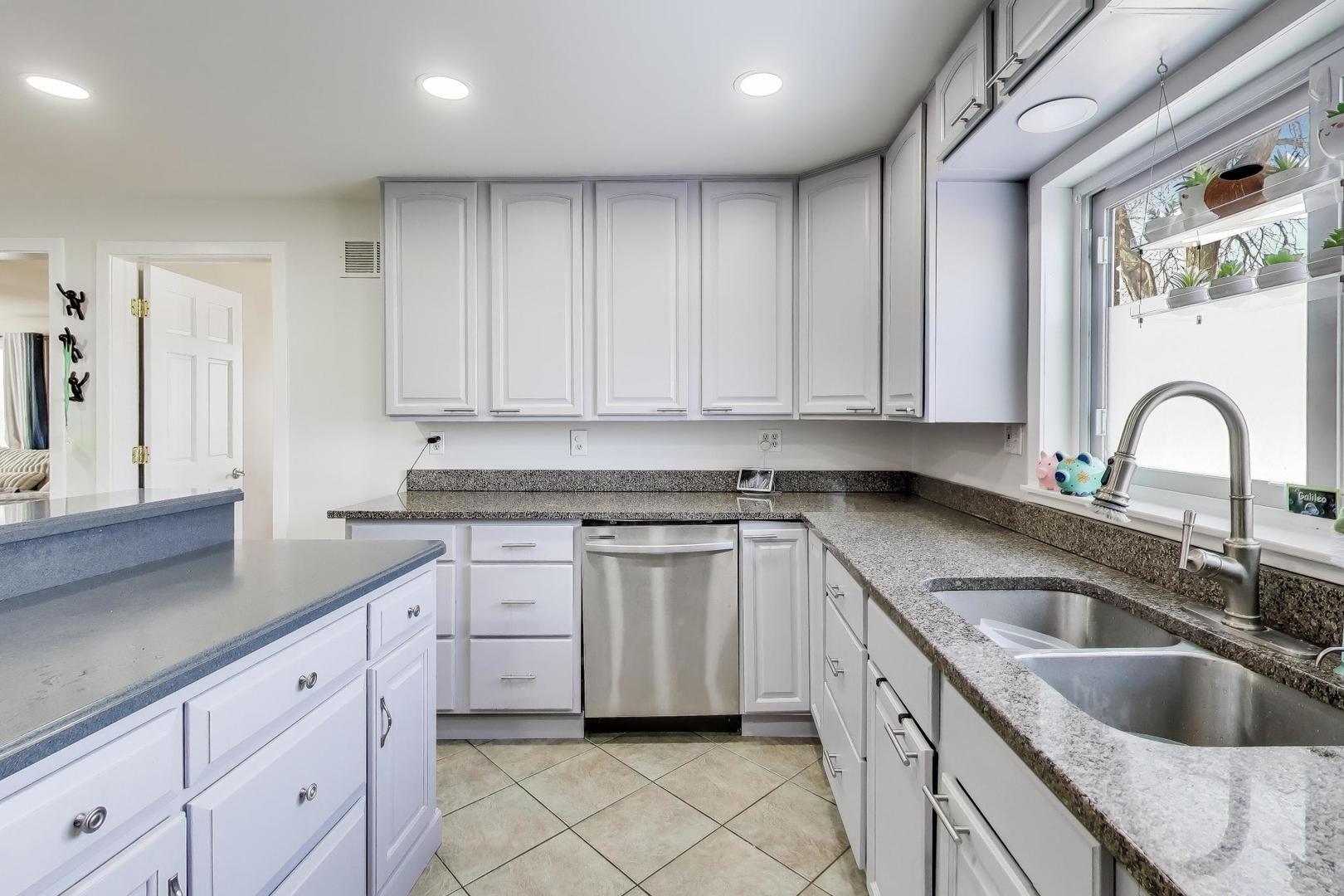 29 Iowa Avenue Addison, IL 60101 - Photo 10 of 31 a kitchen with granite countertop white cabinets and sink