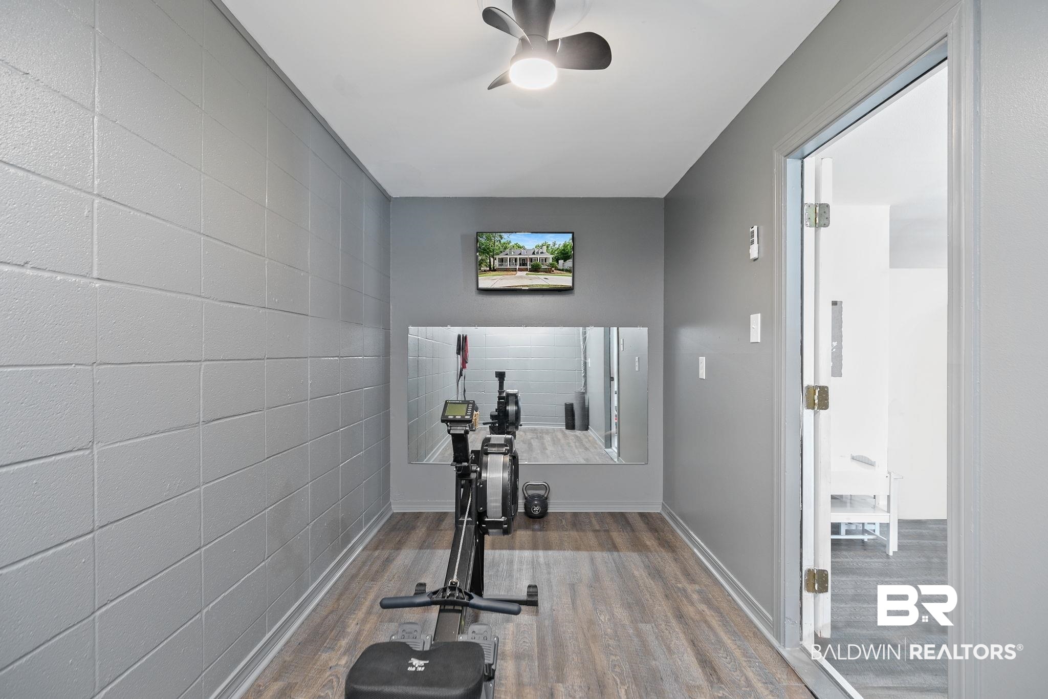 342 Ridgewood Drive Daphne, AL 36526 - Photo 26 of 36 Exercise room featuring ceiling fan and hardwood / wood-style flooring
