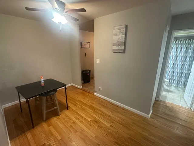 a view of a livingroom with wooden floor and chair