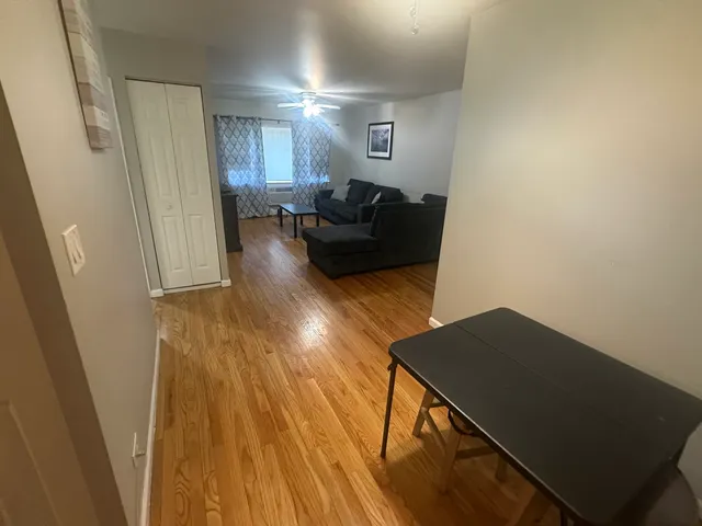 a view of a livingroom with wooden floor and stairs
