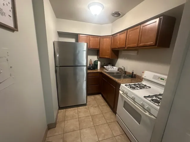 a kitchen with a stove a refrigerator and a sink