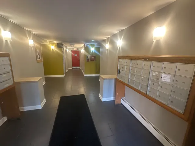 a view of a hallway with wooden shelves