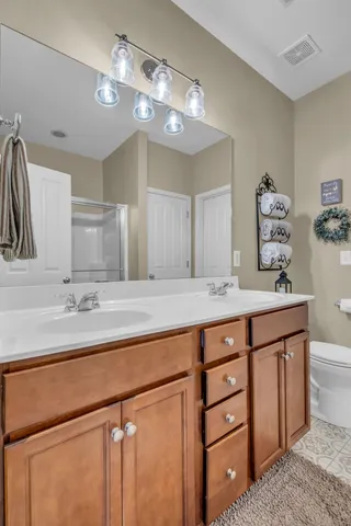 a bathroom with a sink a vanity and a large mirror