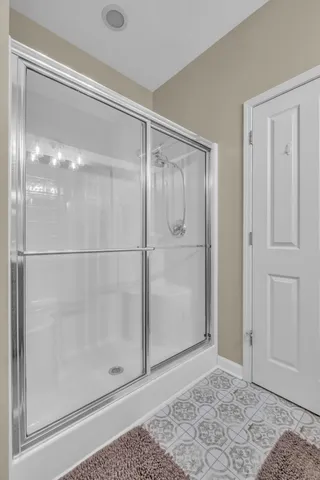 a bathroom with a glass shower door