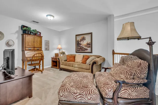 a bedroom with furniture and a mirror